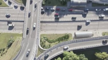 This stock footage shows an aerial view of a traffic intersection with cars driving along it in Kyiv, Ukraine in 8K resolution
