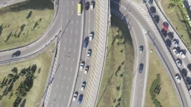 This stock footage shows an aerial view of a traffic intersection with cars driving along it in Kyiv, Ukraine in 8K resolution