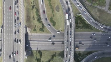 This stock footage shows an aerial view of a traffic intersection with cars driving along it in Kyiv, Ukraine in 8K resolution