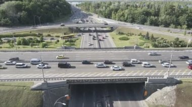 This stock footage shows an aerial view of a traffic intersection with cars driving along it in Kyiv, Ukraine in 8K resolution