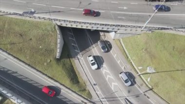 This stock footage shows an aerial view of a traffic intersection with cars driving along it in Kyiv, Ukraine in 8K resolution