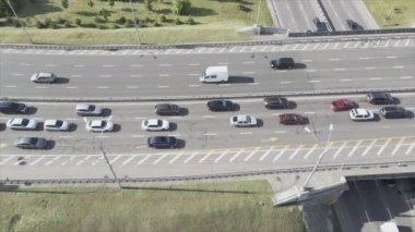 This stock footage shows an aerial view of a traffic intersection with cars driving along it in Kyiv, Ukraine in 8K resolution