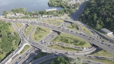 This stock footage shows an aerial view of a traffic intersection with cars driving along it in Kyiv, Ukraine in 8K resolution