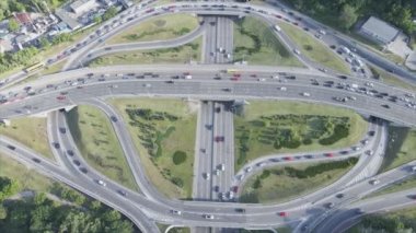 This stock footage shows an aerial view of a traffic intersection with cars driving along it in Kyiv, Ukraine in 8K resolution