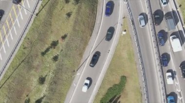 This stock footage shows an aerial view of a traffic intersection with cars driving along it in Kyiv, Ukraine in 8K resolution