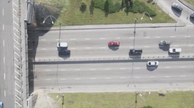 This stock footage shows an aerial view of a traffic intersection with cars driving along it in Kyiv, Ukraine in 8K resolution