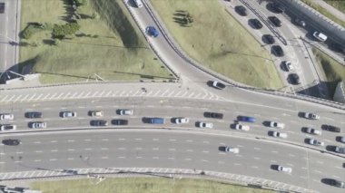This stock footage shows an aerial view of a traffic intersection with cars driving along it in Kyiv, Ukraine in 8K resolution