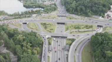 This stock footage shows an aerial view of a traffic intersection with cars driving along it in Kyiv, Ukraine in 8K resolution