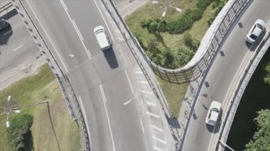 This stock footage shows an aerial view of a traffic intersection with cars driving along it in Kyiv, Ukraine in 8K resolution
