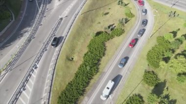This stock footage shows an aerial view of a traffic intersection with cars driving along it in Kyiv, Ukraine in 8K resolution