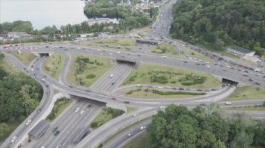 This stock footage shows an aerial view of a traffic intersection with cars driving along it in Kyiv, Ukraine in 8K resolution