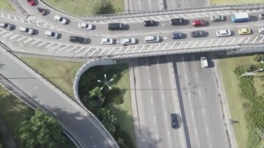 This stock footage shows an aerial view of a traffic intersection with cars driving along it in Kyiv, Ukraine in 8K resolution