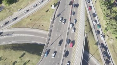 This stock footage shows an aerial view of a traffic intersection with cars driving along it in Kyiv, Ukraine in 8K resolution