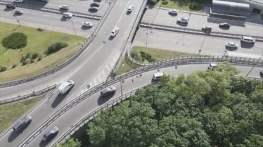 This stock footage shows an aerial view of a traffic intersection with cars driving along it in Kyiv, Ukraine in 8K resolution
