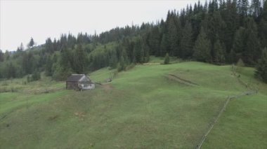 This stock video shows an aerial view of a house in the Carpathian mountains, Ukraine in 8K resolution