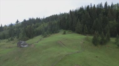 This stock video shows an aerial view of a house in the Carpathian mountains, Ukraine in 8K resolution