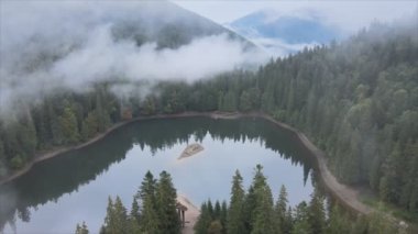 This stock video shows an aerial view of Synevyr Lake in the Carpathian Mountains, Ukraine in 8K resolution