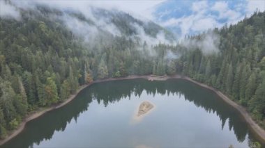 This stock video shows an aerial view of Synevyr Lake in the Carpathian Mountains, Ukraine in 8K resolution