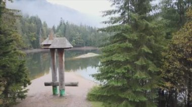 This stock video shows an aerial view of Synevyr Lake in the Carpathian Mountains, Ukraine in 8K resolution