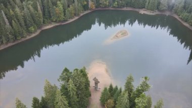 This stock video shows an aerial view of Synevyr Lake in the Carpathian Mountains, Ukraine in 8K resolution