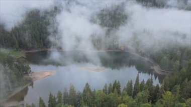 This stock video shows an aerial view of Synevyr Lake in the Carpathian Mountains, Ukraine in 8K resolution
