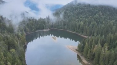 This stock video shows an aerial view of Synevyr Lake in the Carpathian Mountains, Ukraine in 8K resolution