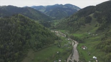 This stock video shows aerial view of a mountain river in the Carpathian Mountains, Ukraine in 8K resolution
