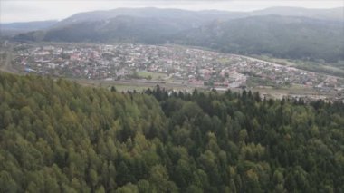 This stock footage shows aerial view of a small village in the forest in the Carpathians, Ukraine in 8K resolution