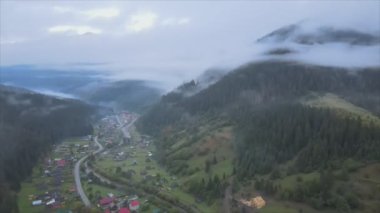 This stock footage shows aerial view of a small village in the forest in the Carpathians, Ukraine in 8K resolution