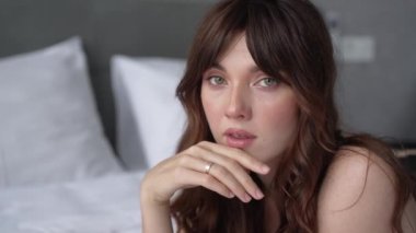 This stock video shows a beautiful woman in sexy lingerie, slow motion