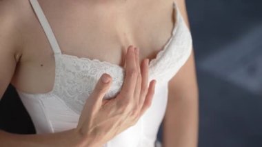 This stock video shows a beautiful woman in sexy lingerie, slow motion