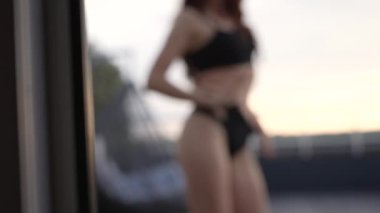 This stock video shows a beautiful woman in sexy lingerie, slow motion