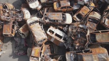 This stock video shows a dump of shot and burned cars in Irpin, Bucha district in 8K resolution