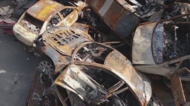 This stock video shows a dump of shot and burned cars in Irpin, Bucha district in 8K resolution