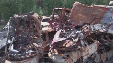 This stock video shows a dump of shot and burned cars in Irpin, Bucha district in 8K resolution