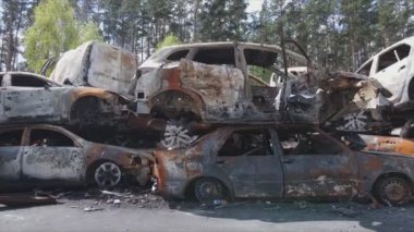 This stock video shows a dump of shot and burned cars in Irpin, Bucha district in 8K resolution