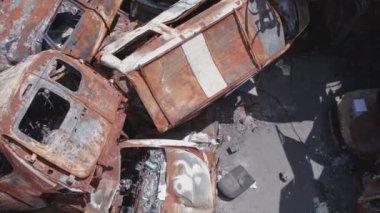 This stock video shows a dump of shot and burned cars in Irpin, Bucha district in 8K resolution