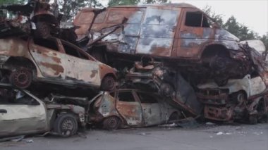 This stock video shows a dump of shot and burned cars in Irpin, Bucha district in 8K resolution