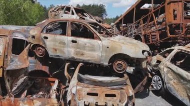 This stock video shows a dump of shot and burned cars in Irpin, Bucha district in 8K resolution