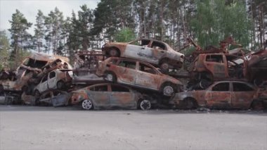 This stock video shows a dump of shot and burned cars in Irpin, Bucha district in 8K resolution