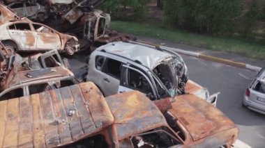 This stock video shows a dump of shot and burned cars in Irpin, Bucha district in 8K resolution