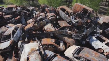 This stock video shows a dump of shot and burned cars in Irpin, Bucha district in 8K resolution