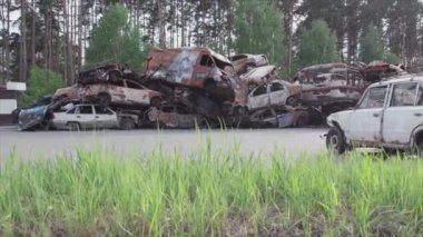 This stock video shows a dump of shot and burned cars in Irpin, Bucha district in 8K resolution