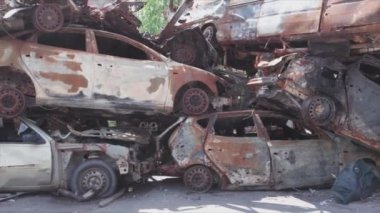 This stock video shows a dump of shot and burned cars in Irpin, Bucha district in 8K resolution
