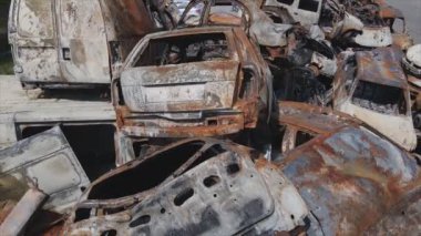 This stock video shows a dump of shot and burned cars in Irpin, Bucha district in 8K resolution