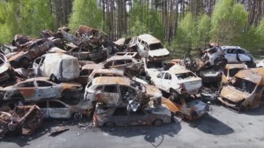 This stock video shows a dump of shot and burned cars in Irpin, Bucha district in 8K resolution