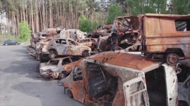 This stock video shows a dump of shot and burned cars in Irpin, Bucha district in 8K resolution