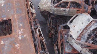 This stock video shows a dump of shot and burned cars in Irpin, Bucha district in 8K resolution