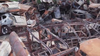 This stock video shows a dump of shot and burned cars in Irpin, Bucha district in 8K resolution