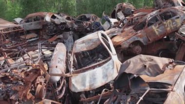 This stock video shows a dump of shot and burned cars in Irpin, Bucha district in 8K resolution